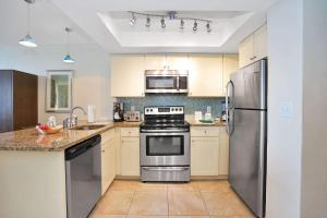 a kitchen with a stainless steel stove and refrigerator at Hollywood Beach Tower - Studio Suite in Hollywood