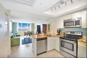 a kitchen with a stove top oven next to a living room at Hollywood Beach Tower - Studio Suite in Hollywood