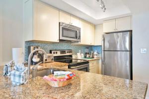 a kitchen with a sink and a stainless steel refrigerator at Hollywood Beach Tower - Studio Suite in Hollywood +18 photos
