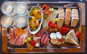 a tray filled with different types of meats and cheese at Park am See in Obertraun +60 photos