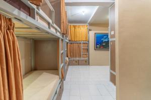 an empty room with bunk beds in it at Aru House Ubud in Ubud