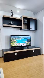 a living room with a large flat screen tv on a wall at Zen Apartament in Alba Iulia