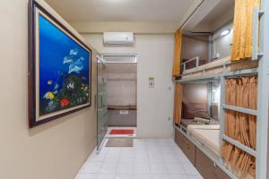 a bathroom with a large painting on the wall at Aru House Ubud in Ubud +69 photos