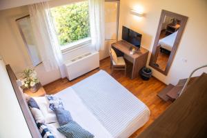 a room with a bed and a mirror and a television at Hotel La Fonte in Osimo
