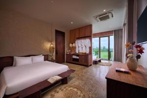a bedroom with a large white bed and a window at ArtLua Boutique Hotel Tam Coc in Văn Lâm +68 photos