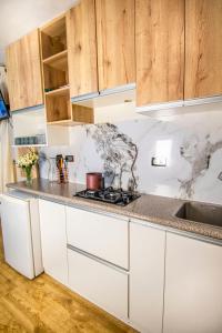 a kitchen with white counter tops and wooden cabinets at Alpacasa Arequipa in Arequipa +16 photos