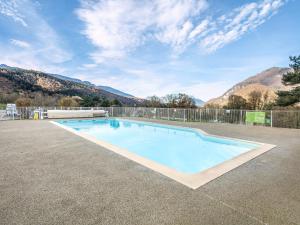 a large swimming pool with mountains in the background at Birdie H N21 ST2 in Giez