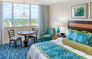 a hotel room with a bed and a table and chairs at Hollywood Beach Tower - Hotel Room in Hollywood