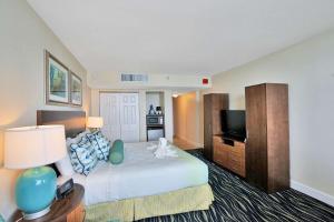 a hotel room with a bed and a flat screen tv at Hollywood Beach Tower - Hotel Room in Hollywood