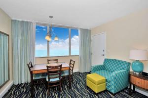 a living room with a table and a chair and a couch at Hollywood Beach Tower - Hotel Room in Hollywood