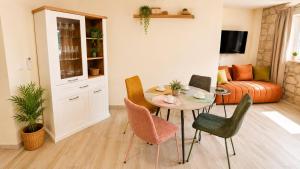 a living room with a table and chairs at Haven Bay Apartment in Rogotin