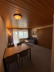 a living room with a table and chairs and a couch at Gonenstein 11 in Leukerbad
