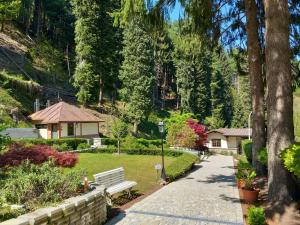 a park with a bench and a house and trees at Sam's Getaway in Lurisia