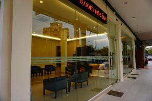 a store window with chairs and a table in it at Hotel Alpha in Bukit Mertajam