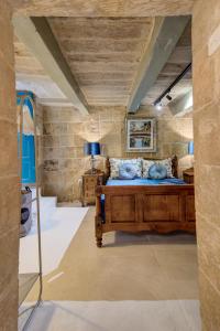 a bedroom with a large wooden bed in a room at Valletta Boutique Residence in Valletta