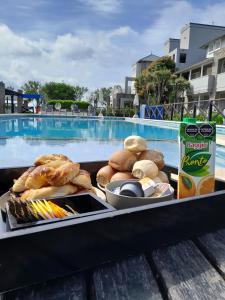 a tray of food on a table next to a pool at Refugio de Mar in Miramar