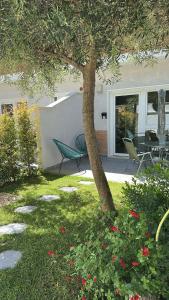 a house with a table and chairs in a yard at ComfortHouse AlbatrosMare in Ladispoli