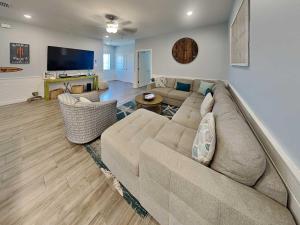 a large living room with a large couch and chairs at Port As Flip Flops & Pop Tops in Port Aransas