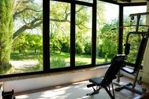a room with a window with a chair and a treadmill at Mas Joanmiquel - Masía histórica exclusiva in Les Olives +40 photos