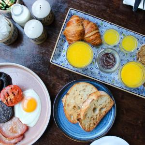 a table topped with plates of breakfast foods and eggs at Kilkenny Pembroke Hotel in Kilkenny