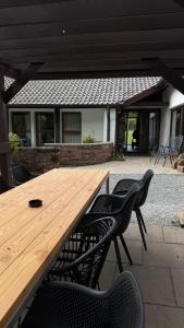 a wooden table and chairs in a patio at Ferienhaus 76 in Freudenstadt