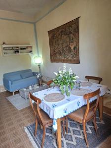 a living room with a table and a blue couch at Millenovecento in Cremona