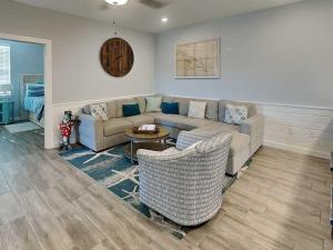 a living room with a couch and chairs at Port As Flip Flops & Pop Tops in Port Aransas