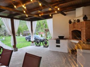 a living room with a fireplace and a car parked in a yard at A frame Ina și Cristi in Tîrsa