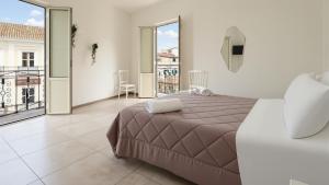 a bedroom with a large bed and a balcony at Il Marchesino B&B in Pizzo