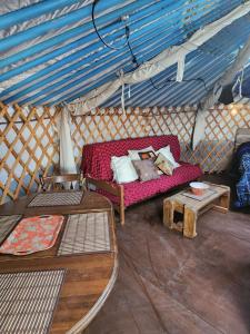 a living room with a couch in a yurt at COTC - The Coulee Yurt - Suite in Castor