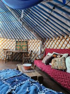 a room with a couch and a table in a yurt at COTC - The Coulee Yurt - Suite in Castor +39 photos