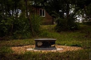 a bird bath sitting in the middle of a yard at COTC - The Grouse House - Suite in Castor