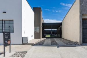 a large white building with a large garage at Casa en San Rafael - 6 personas con parrilla y cochera in San Rafael