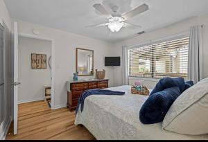 a bedroom with a bed and a ceiling fan at Mystic Sands in Emerald Isle