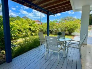 a patio with a table and chairs on a deck at Villa del Carmen Boqueron in Cabo Rojo