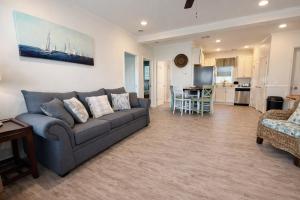 a living room with a couch and a kitchen at Beautiful Pensacola beach house in Pensacola Beach