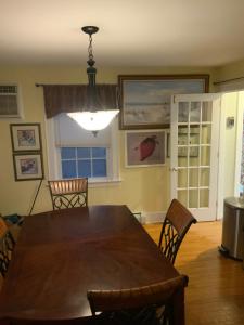 a dining room with a wooden table and chairs at Half a Mansion in Pomfret