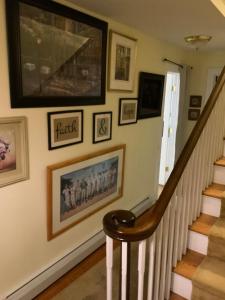 a stairway with pictures on the wall and a stair case at Half a Mansion in Pomfret