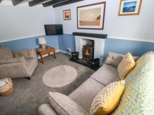 a living room with a couch and a fireplace at Beacon House in Haverfordwest