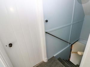 a stairway with a glass door in a room at Beacon House in Haverfordwest +26 photos