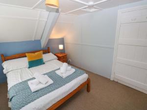 a bedroom with a bed with two towels on it at Beacon House in Haverfordwest