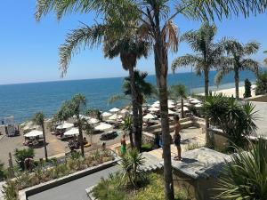 a view of a beach with umbrellas and the ocean at Rana e Hedhun Beach House in Shëngjin