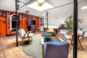a living room with a couch and chairs and a table at Asile Flottant in Amsterdam