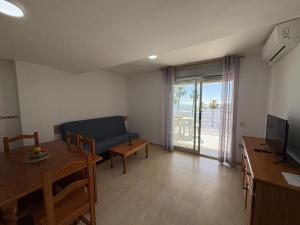 a living room with a couch and a table at Alpen1 Pompeya in Peniscola