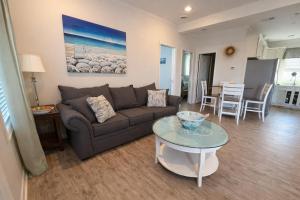a living room with a couch and a table at Beautiful Pensacola beach house in Pensacola Beach +15 photos