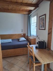 a bedroom with a bed and a desk and a table at Hotel & Restaurant Rössli in Seedorf +32 photos