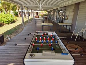 a ping pong table on the deck of a house at Marina View in Les Trois-Îlets