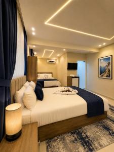 a bedroom with a large bed with a large white bedspread at Dima Plaza Pyramids View in Cairo