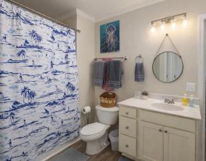 a bathroom with a blue and white shower curtain at Beautiful Pensacola beach house in Pensacola Beach