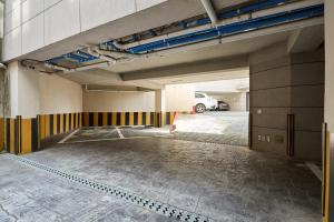 an empty parking garage with a car parked in it at soul stay 2 in Busan